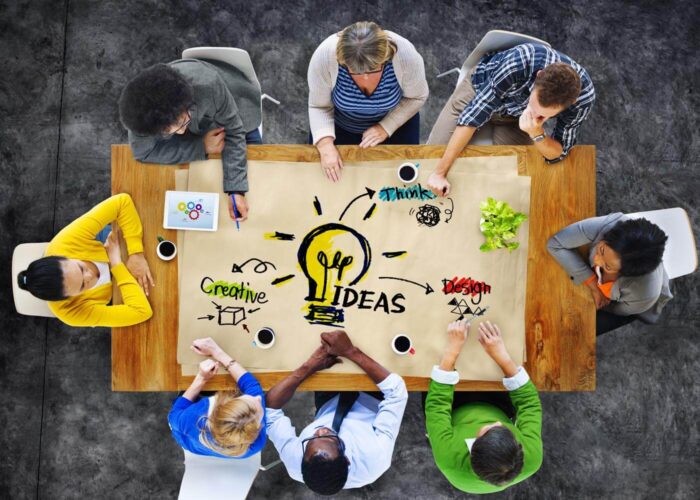 people sitting around a table discussing ideas