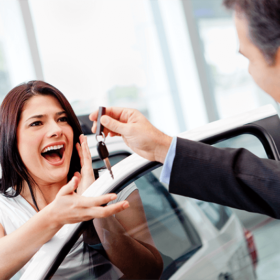 Woman being given car keys