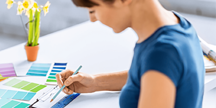 Achieving Brand Consistency Through Color Management person looking on print color swatches