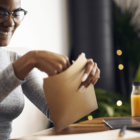 Image: young person opening up an envelope