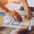 Close-up of people outlining website layout