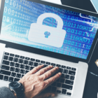 Image: person on a computer with a padlock on the screen