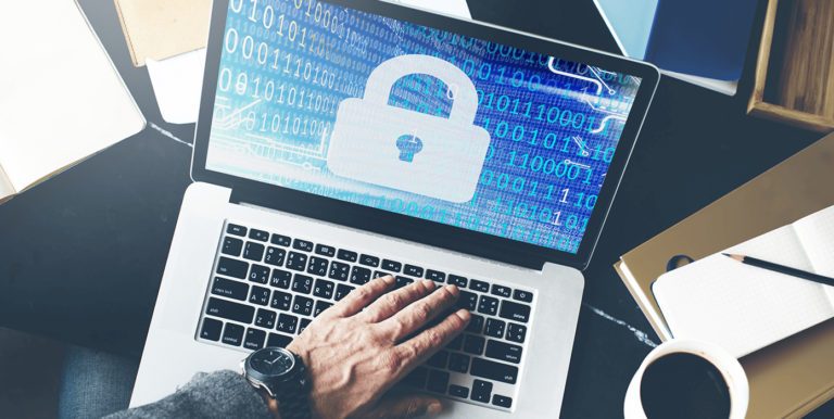 The Importance of Data Security and Privacy person on a computer with a padlock on the screen