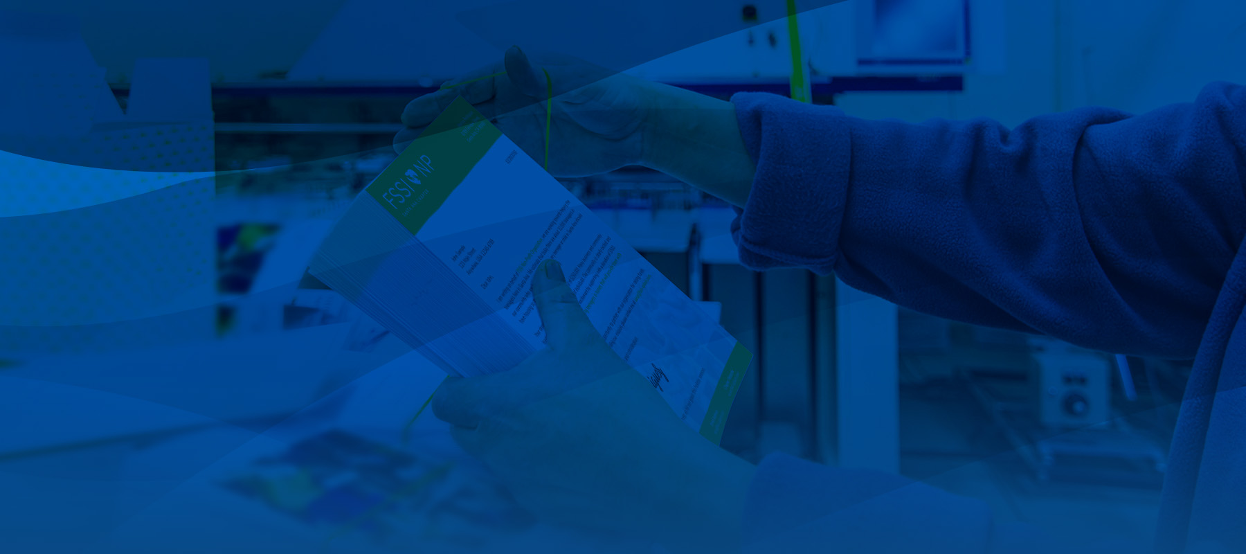 Worker preparing envelopes for mailing