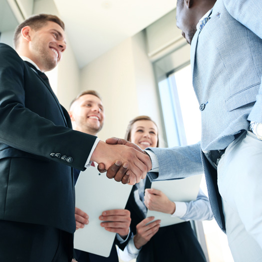 Business meeting with two people shaking hands