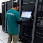 person standing in a server room.