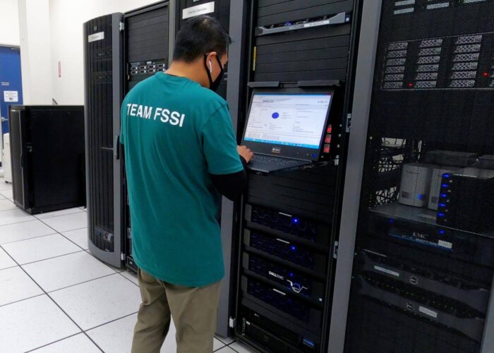 person standing in a server room.