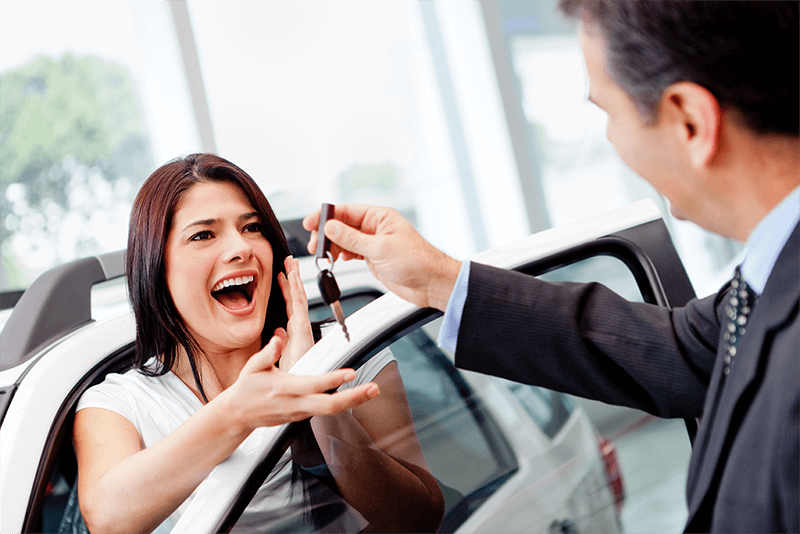 Woman being given car keys.