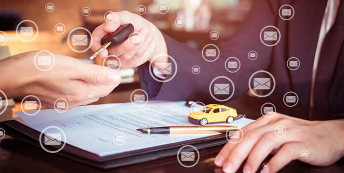 Loan documents with a toy car and someone being handed a car key