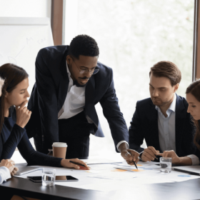 People Standing and Talking in a Board Room.