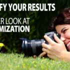 Image: girl with camera laying on the grass shooting close ups