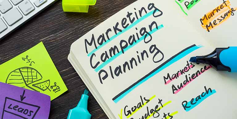 a notebook with marketing campaign planning highlighted