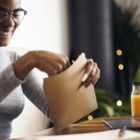 young person opening up an envelope.