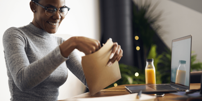 young person opening up an envelope.