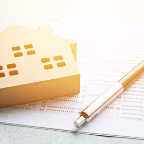 Small wooden house next to a pen and contract.