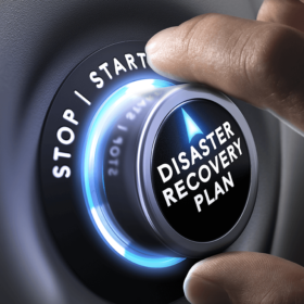 Hand turning a dial that says disaster recovery plan.